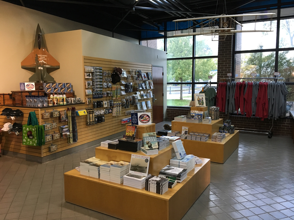 Books and other small items arranged on tables and a wall