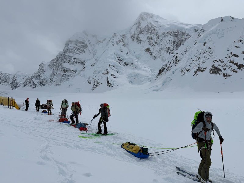 7 mountaineering rangers in a row on skis 