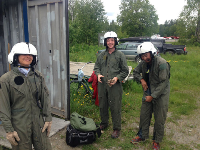 Three volunteers in flight suits and helmets
