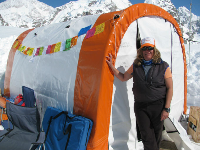 Woman standing in front of colorful tent
