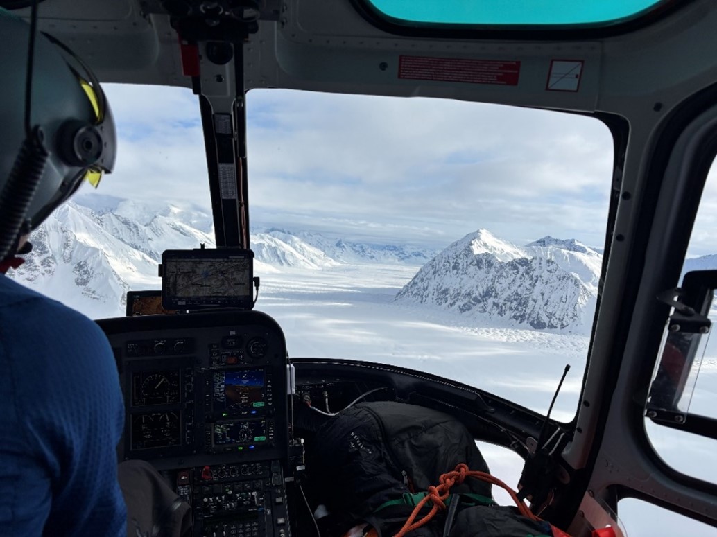 View of a snow covered glacier from the window a helicopter