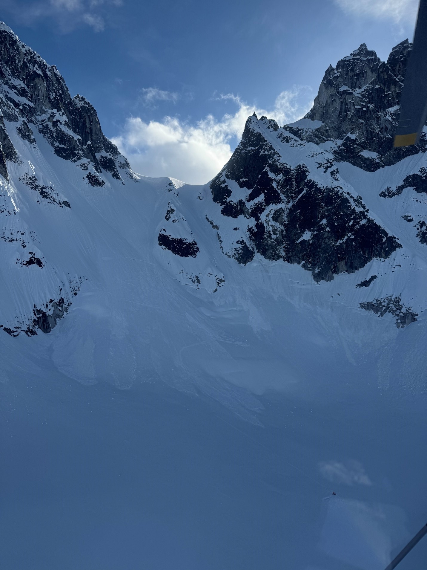 Snow covered mountain peaks with blue sky in the background 
