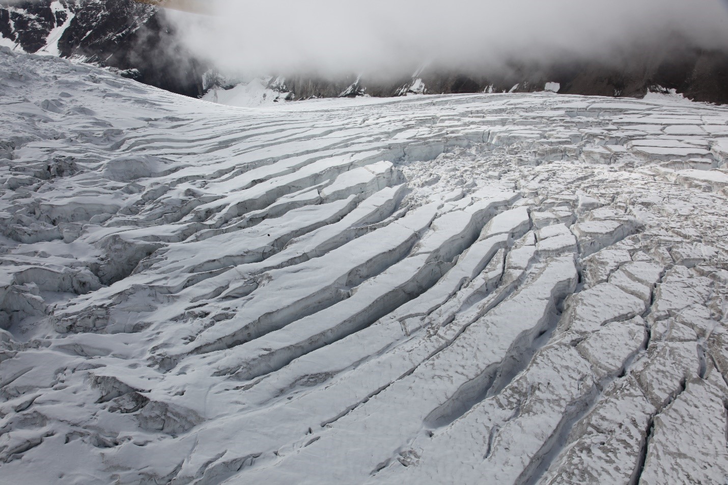 Deep crevasses every few yards slice up a glacier surface