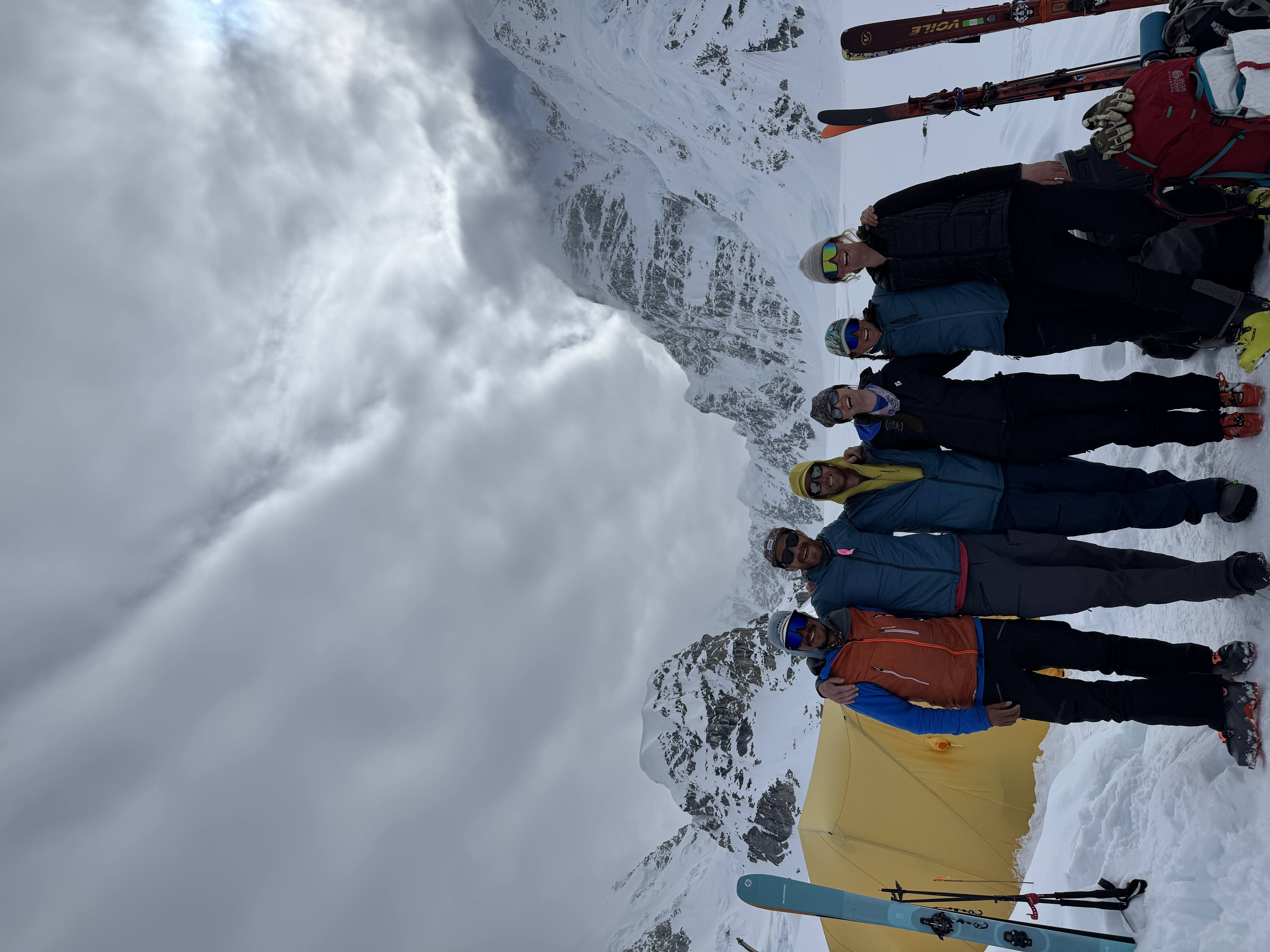 6 rangers stranding a line and smiling at the camera at basecamp