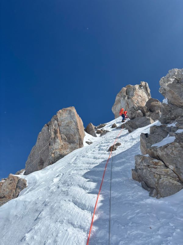 A mountaineering ranger climbs