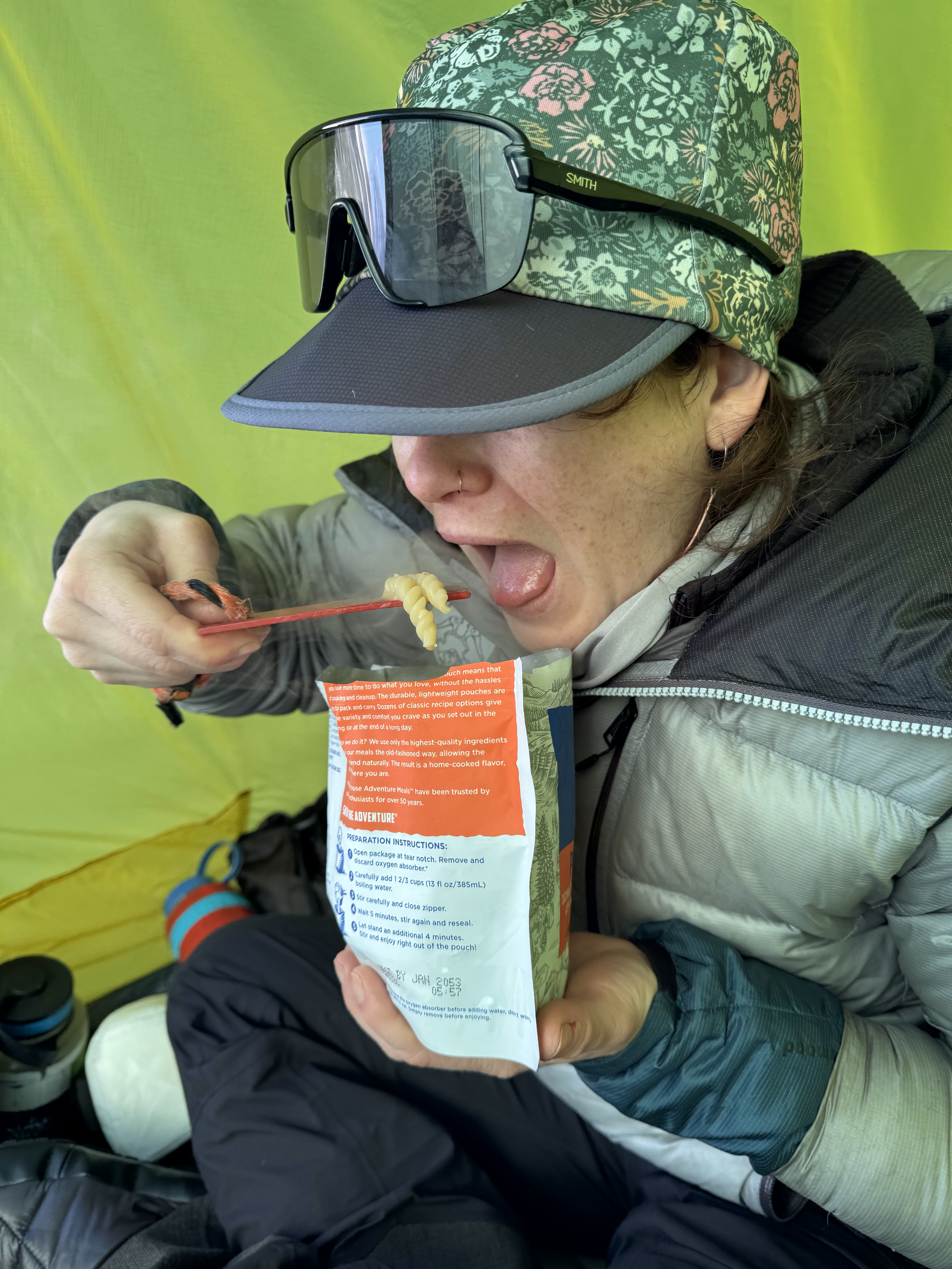 Ranger eats noodles out of a pouch with a wooden spoon