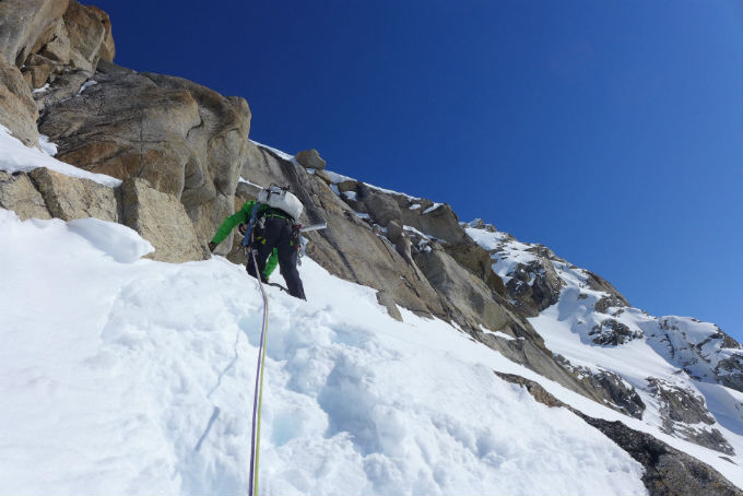 Roped climber on snow and rock