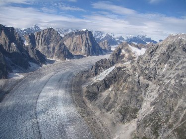 Aerial view of mountains above a river of ice
