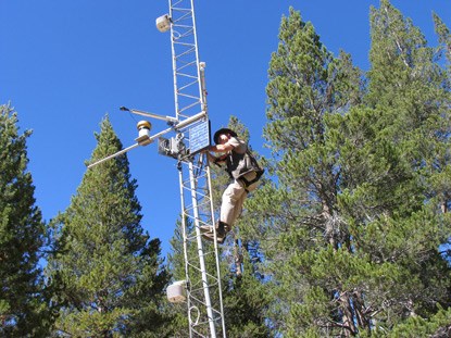 Person climbing weather station tower