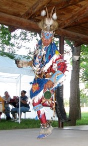 An Arapaho dancer performing a ceremony in traditional regalia