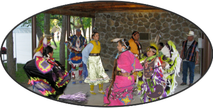 A group of Arapahos dance in traditional regalia