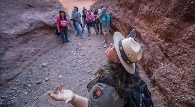 A ranger guides a hike in a canyon
