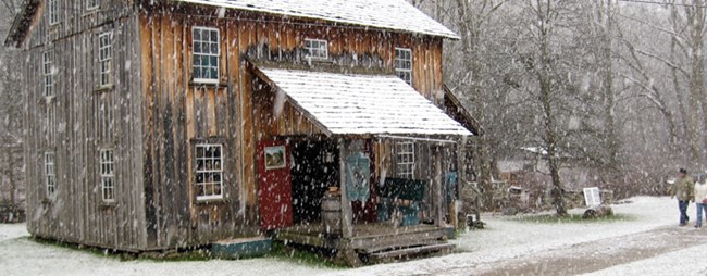 old house with snow falling