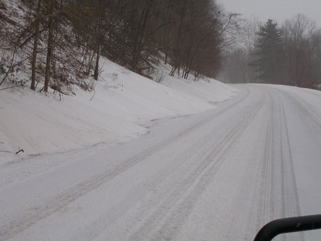 Route 209 completely covered in snow during a storm.