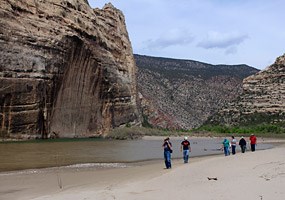 Hikers walk along the beach near the confluence of the Green and Yampa Rivers.