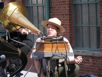 Curator Jerry Fabris checks the early phonograph during a wax cylinder recording.