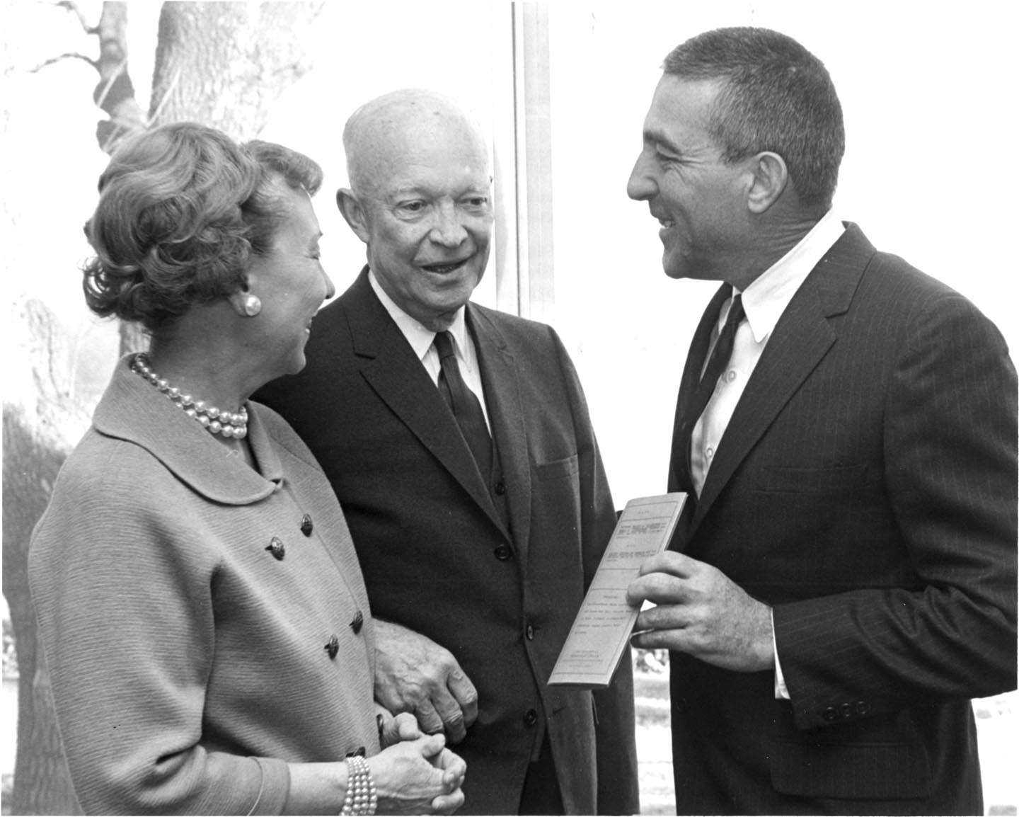 Mamie and Dwight Eisenhower hand over the deed to their property to Stewart Udall, Secretary of the Interior