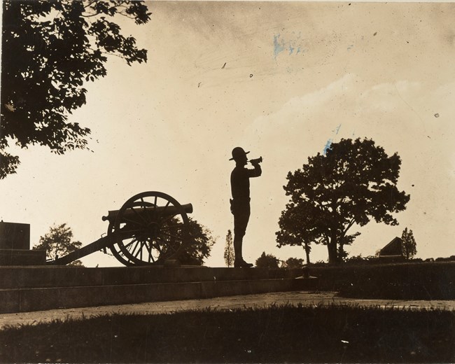 A silhouette of a bugler on Cemetery Ridge at Camp Colt