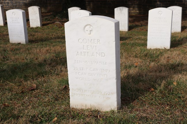 A white headstone for Comer Levi Altland