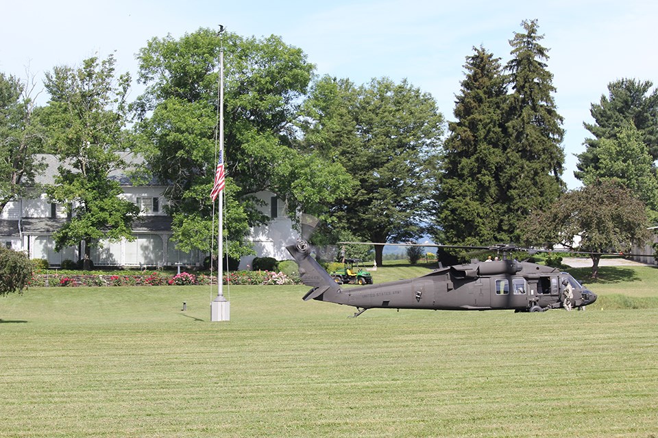 A black hawk helicopter sits in the fields behind the Eisenhower home.