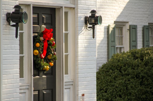 A colorful wreath hangs on the front door of the Eisenhower home