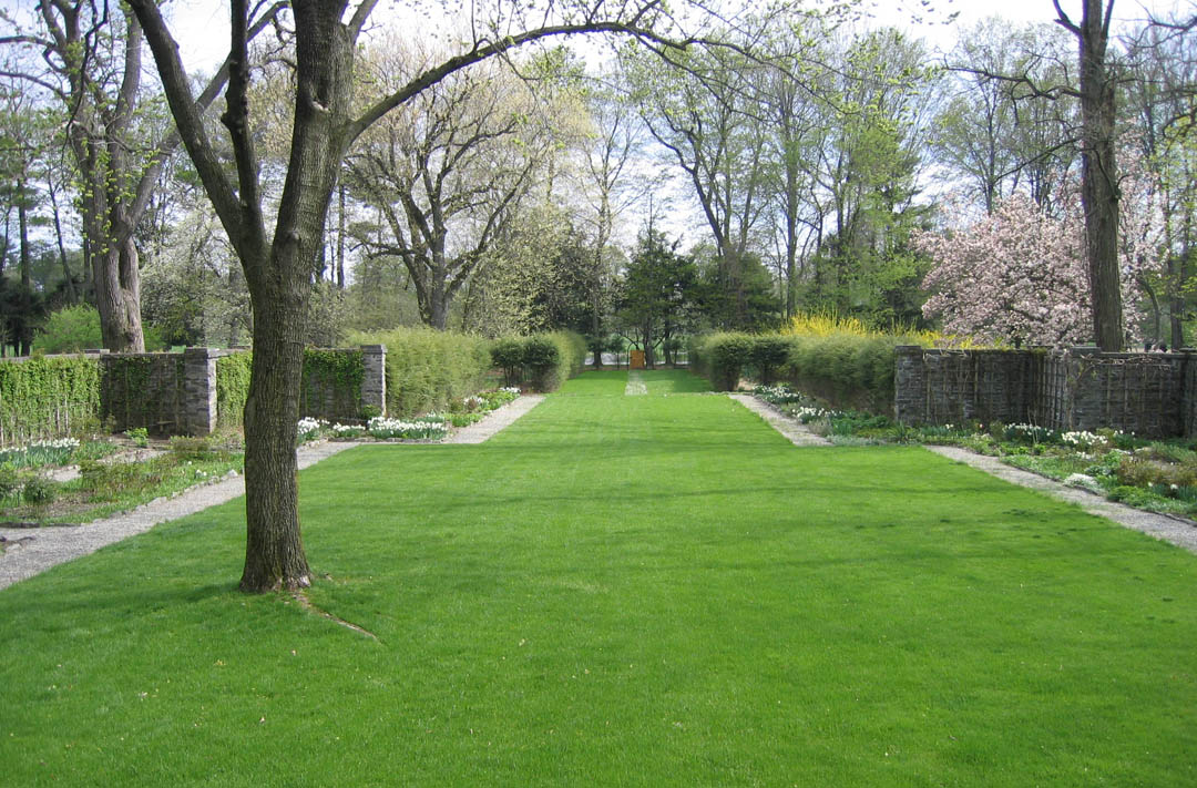 A grassy lawn within a walled garden