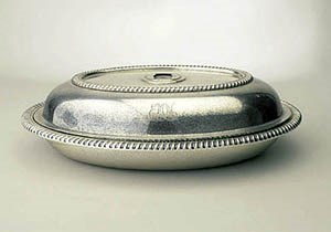 An oval-shaped silver vegetable dish with lid, missing it's finial, monogrammed EMN, for Eleanor, Marion, Nancy.