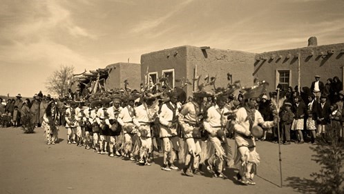 black and white picture of men lined up dancing
