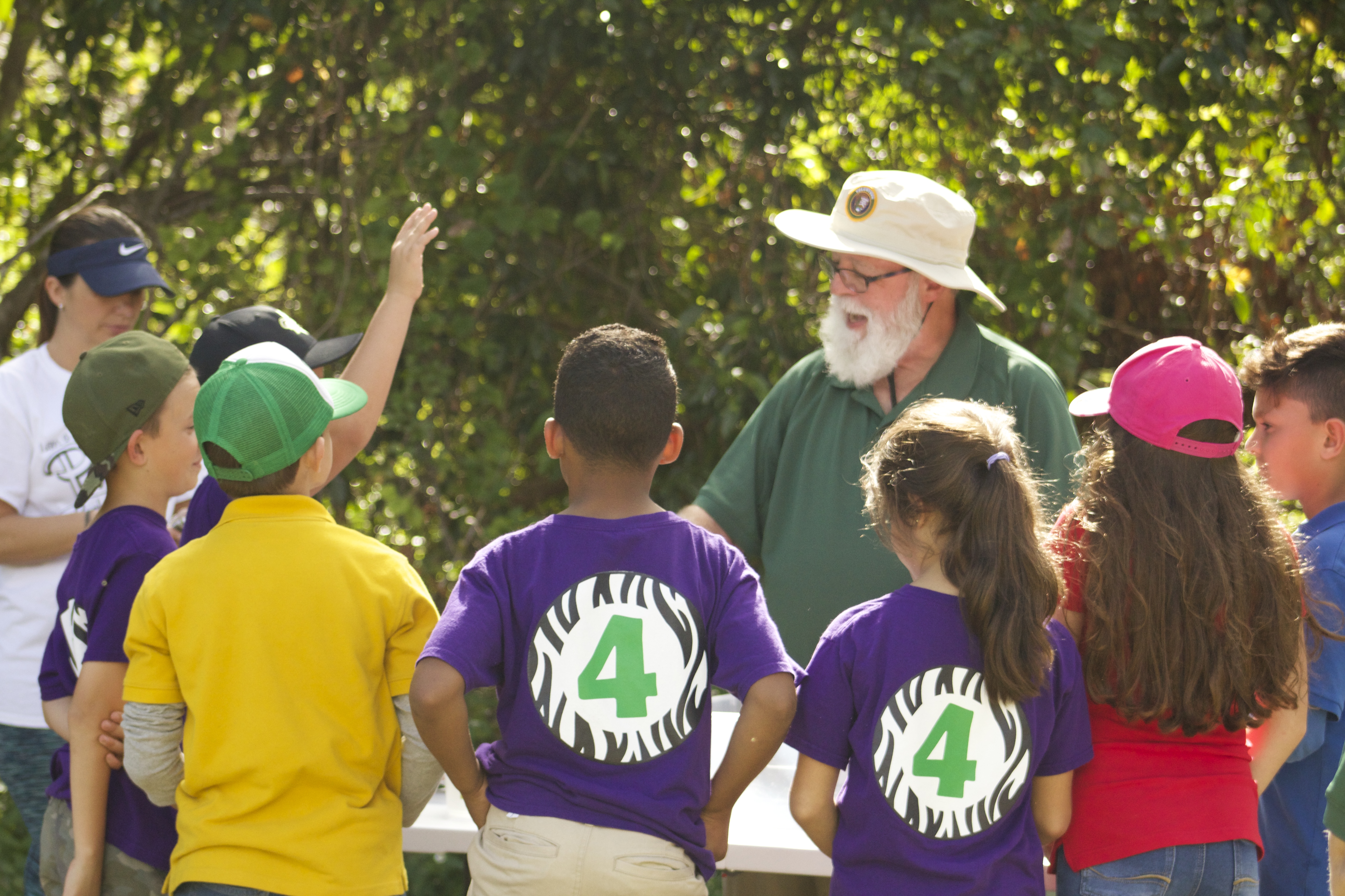 A volunteer speaks to a group of school children