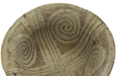 View from above of aged cracked bowl with patterns on the inside.
