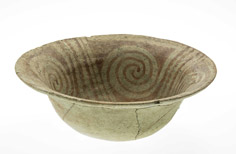 Top down view of aged cracked bowl with patterns on the inside.