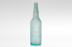 Aged aqua glass liquor bottle with crown finish on neck.