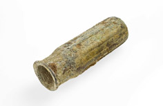 Aged piece of metal tube with a hole.