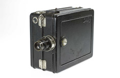 Old camera with black, rectangle-shaped casing.