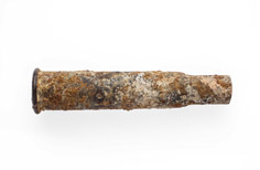Aged piece of metal tube with a hole on each side.
