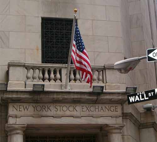 American flag flying at the New York Stock Exchange building on Wall Street.