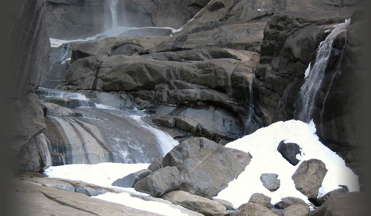 Man explores grand waterfalls in the snow
