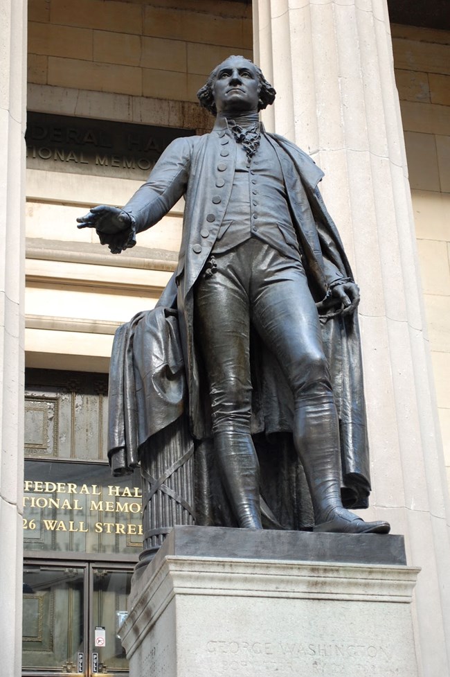 Statue of George Washington taking the oath of office, created by John Quincy Adams Ward in 1883, on front steps of Federal Hall.