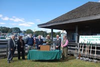 Acting Superintendent McGuinness, in NPS uniform, welcomes guest speakers at the podium.