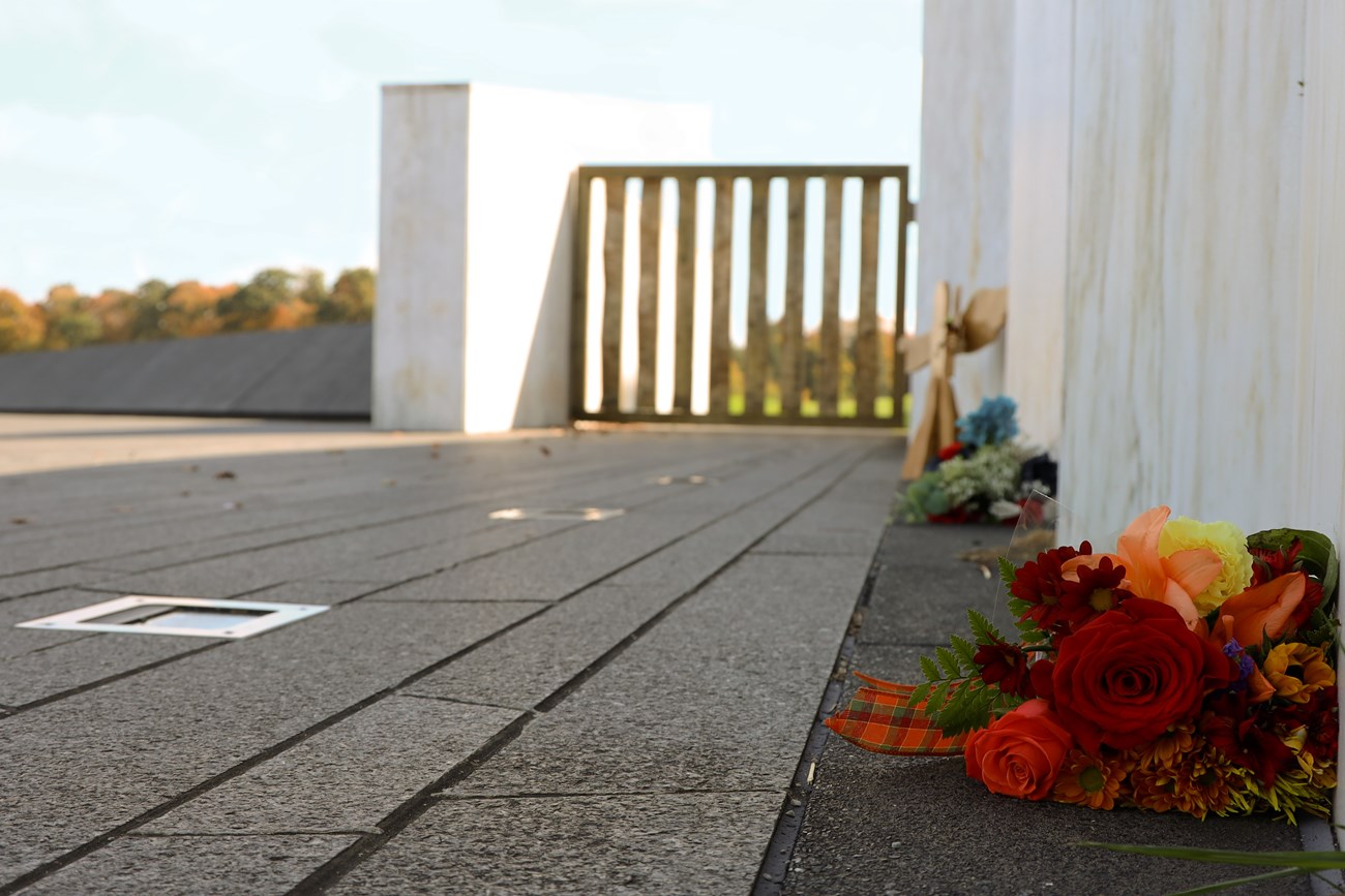 bundle of flowers placed on a black granite walkway