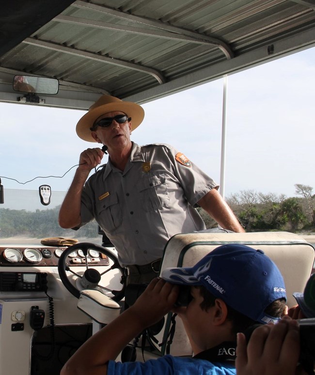 Park Ranger talking on a boat