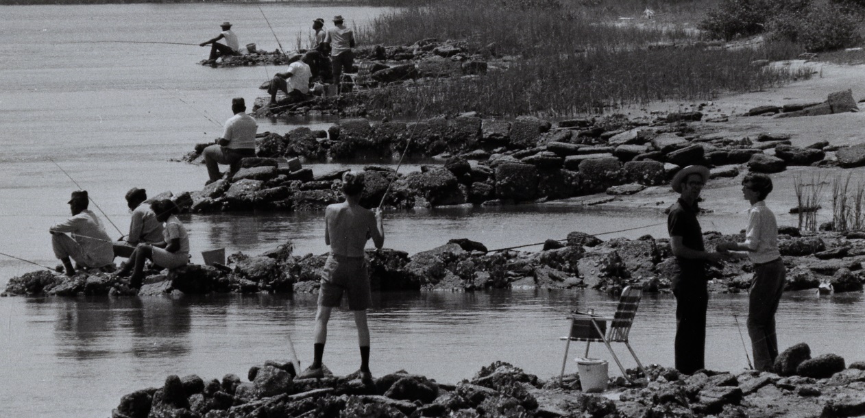 Locals fishing from the shoreline rocks