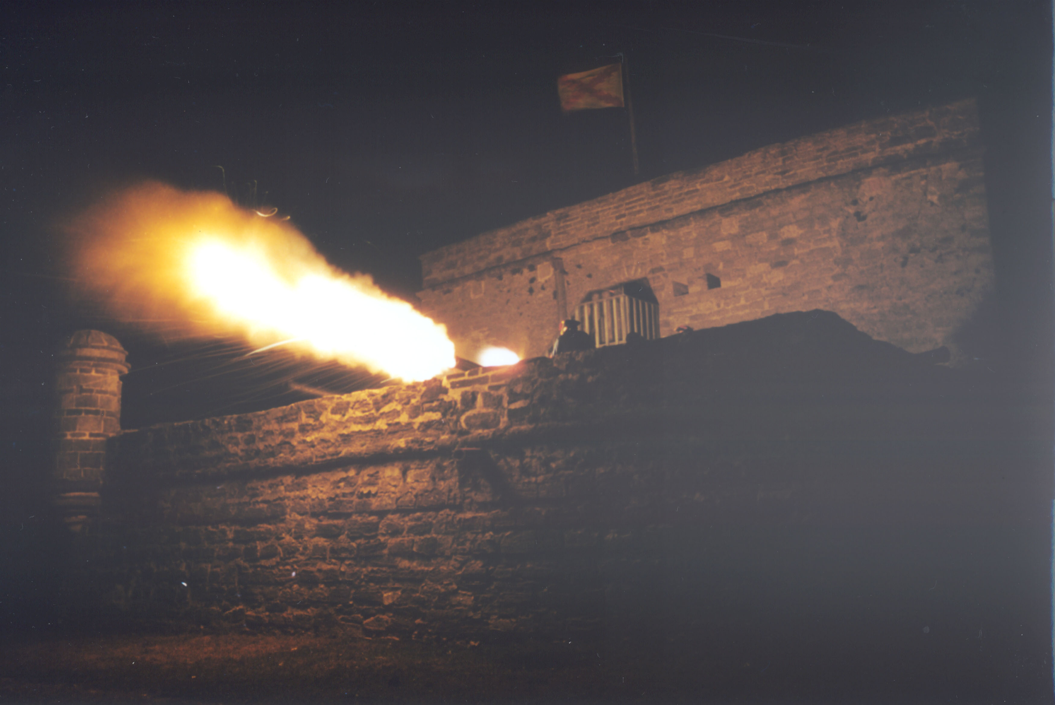 Cannon firing from the fort at night