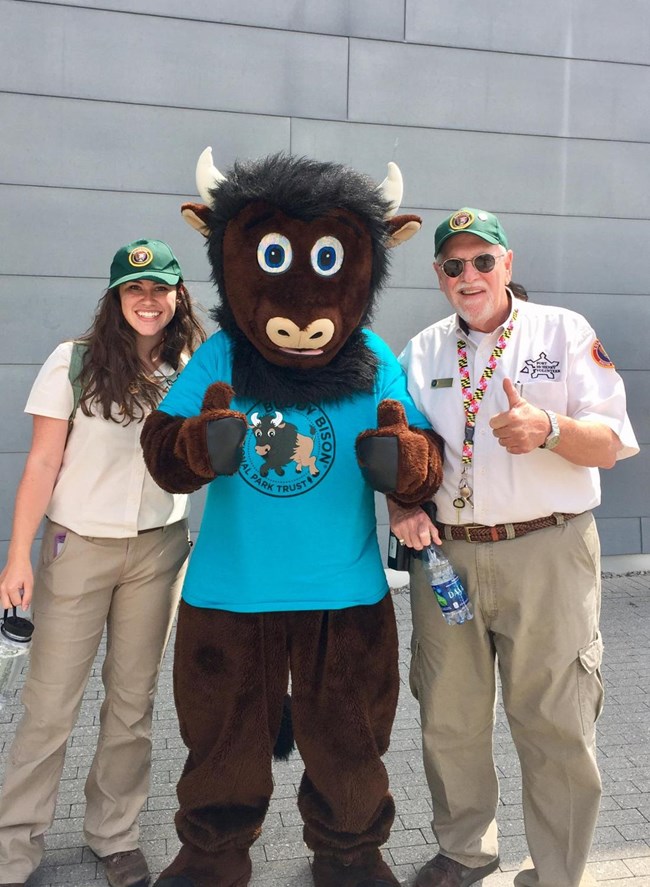 Visitor Services volunteers stand with Buddy Bison