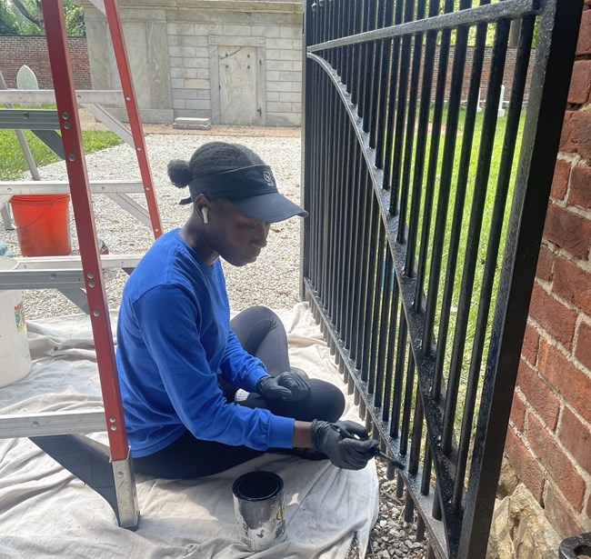 Intern painting iron cemetery gate