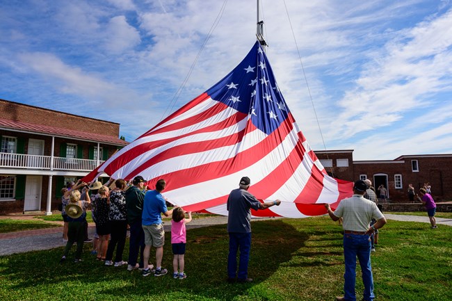 Visitors assisting with flag change in star fort