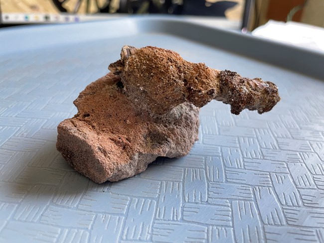 lump of rust stuck to a brick