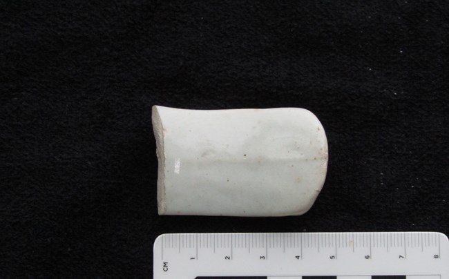 thumb-sized white fragment of a handle