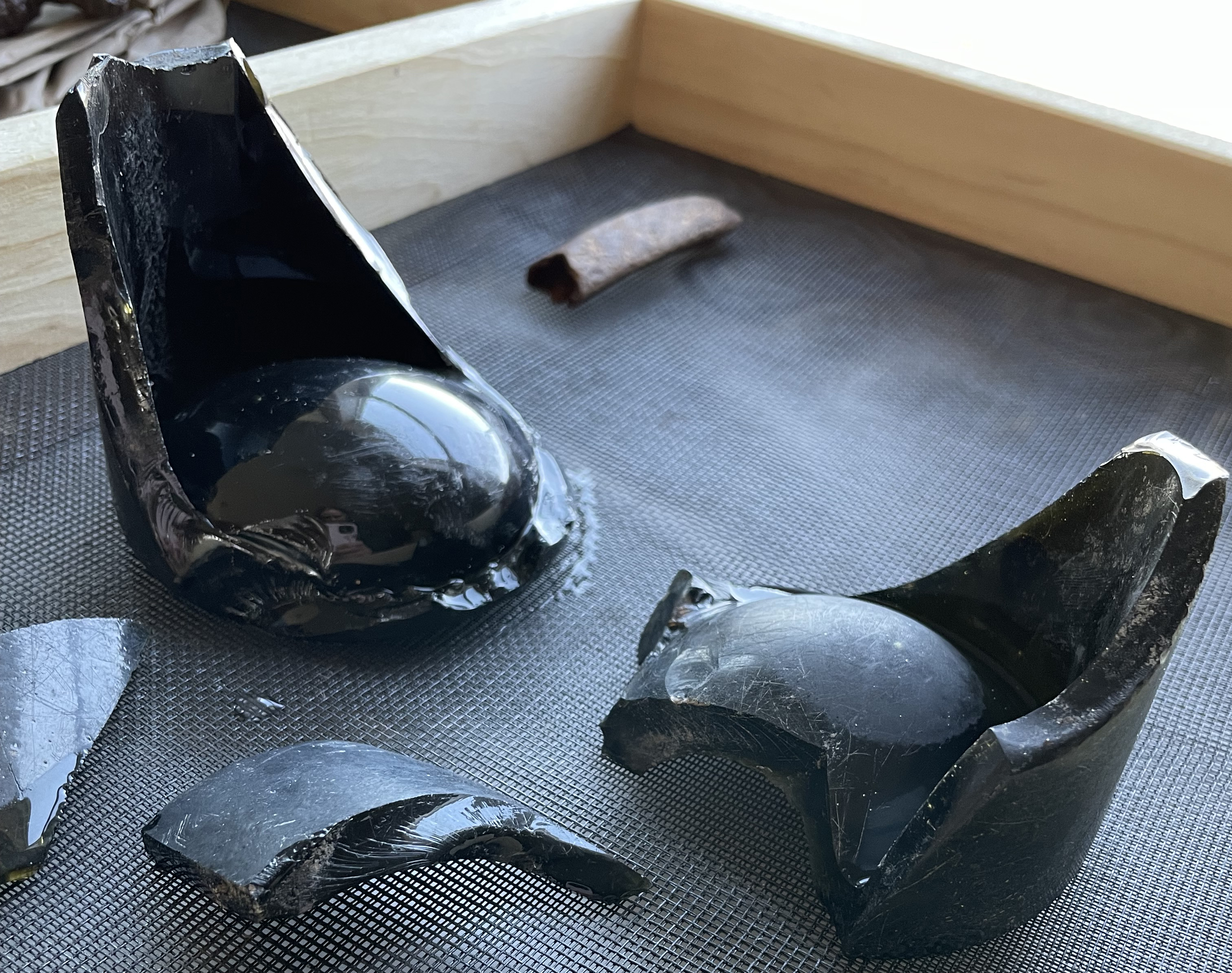 fragments of glass bottles sit in a drying rack
