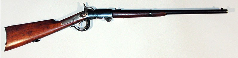 A breech-loading carbine with a black barrel and wood stock on a white background